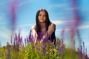 Beautiful fashion woman among purple flowers